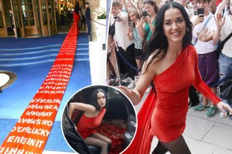 Katy Perry's long train printed with 'Woman's World' lyrics