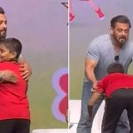 Salman Khan gives a hug to a young fan on stage as he touches his feet at Ganesh Chaturthi event